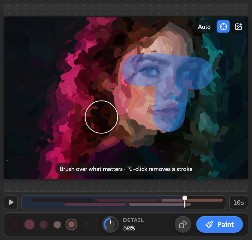 Painted in focus mode with two blue focus strokes over a face, the brush ring under the cursor, and the Auto, focus, and image buttons in the corner.